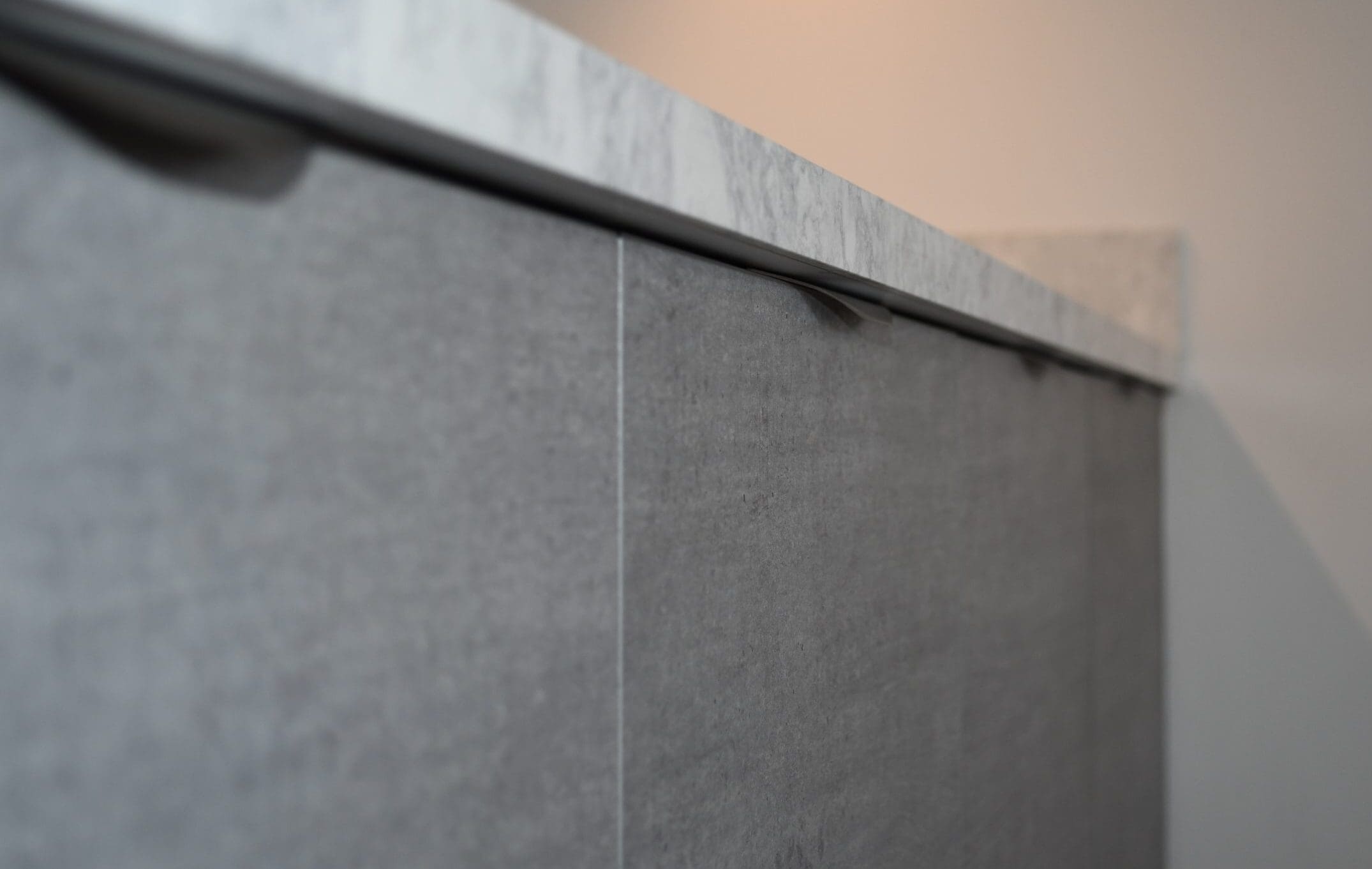 Concrete Slab Kitchen with minimalist stainless steel handles Stonemill Kitchens