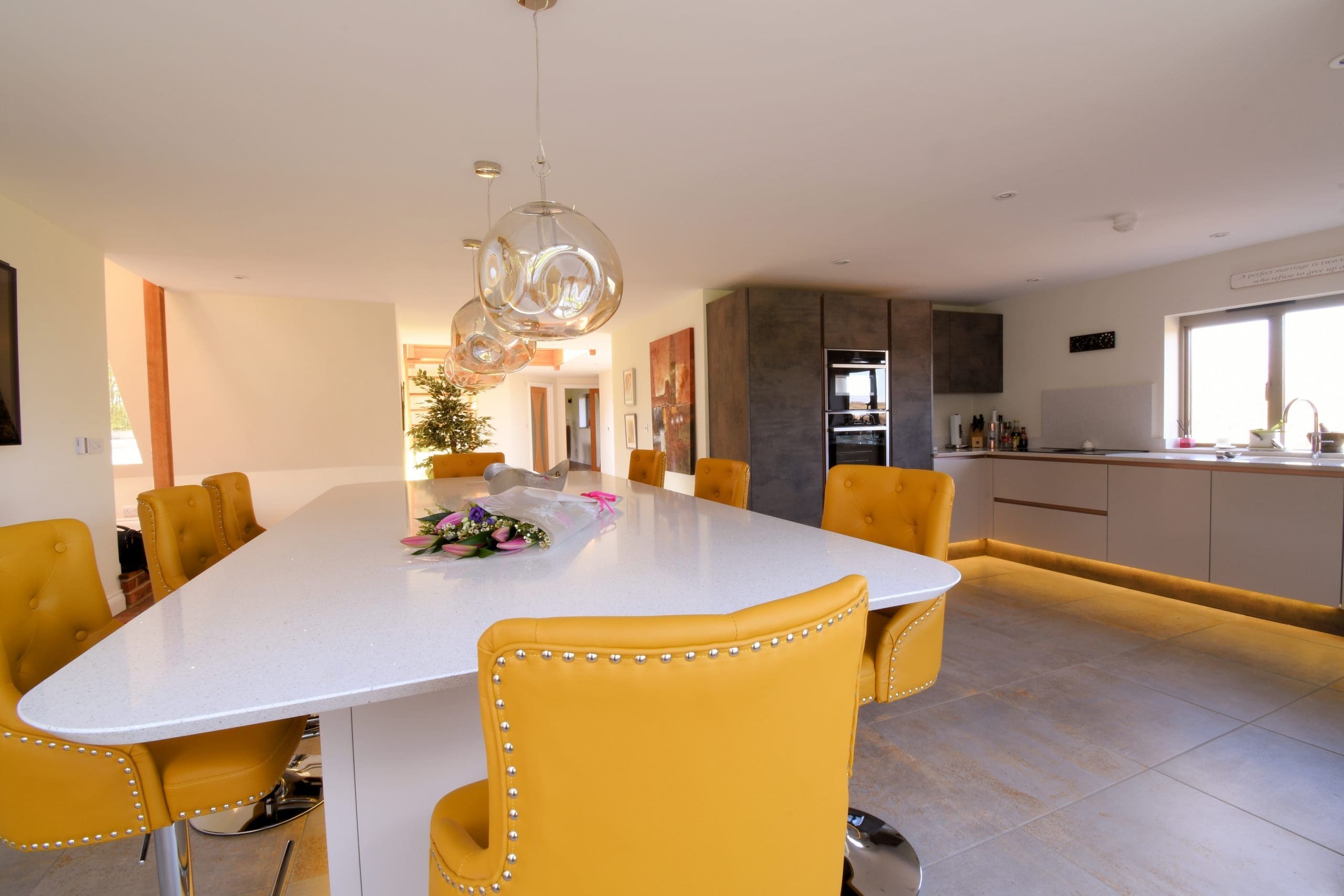 Oxide and Cashmere Kitchen with Flowers Two Tone, Central Island with Neff Ovens, Integrity Sink and Elica Venting Hob with Quartz Worktops True Handleless Rose Gold Rails Stonemill Kitchens