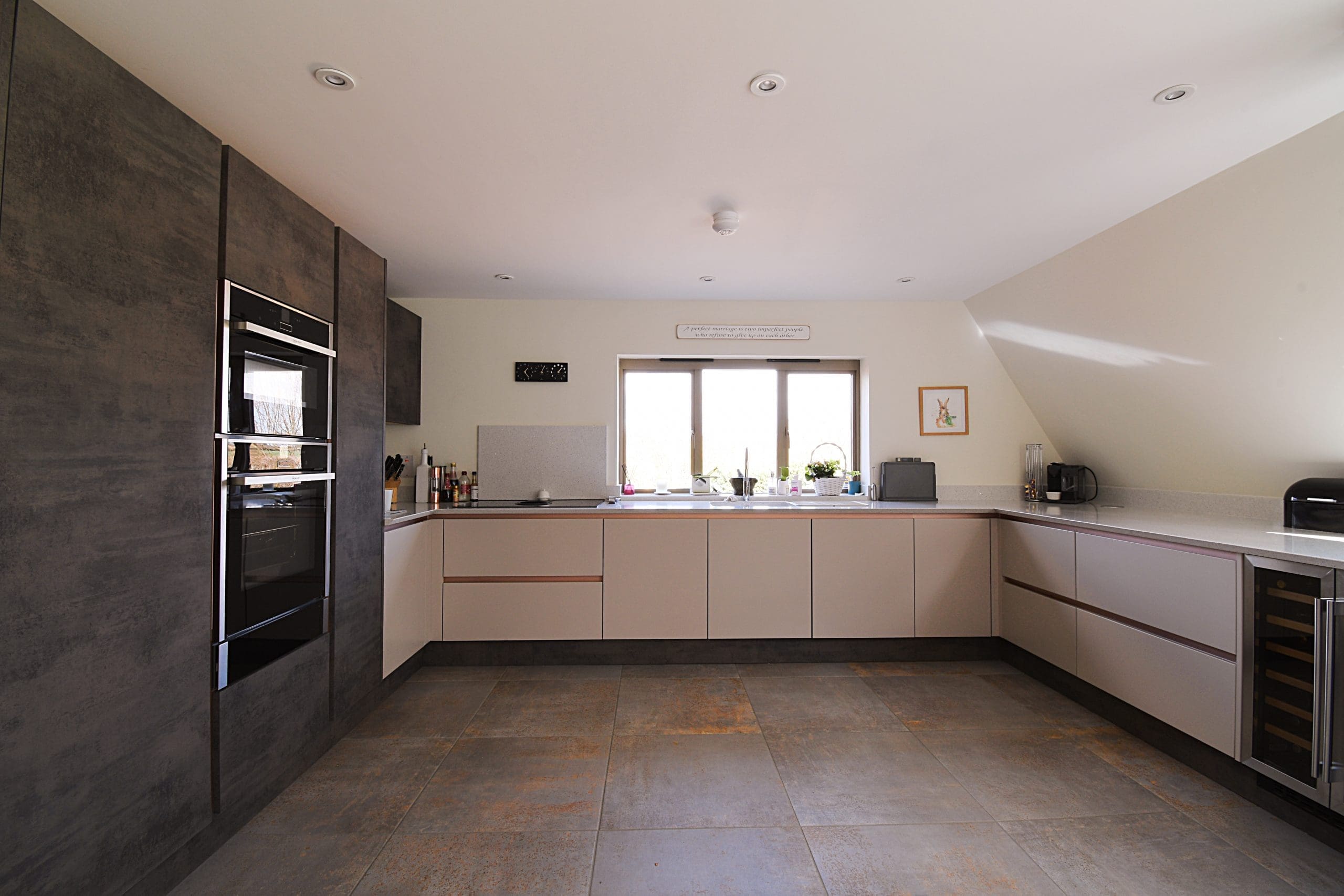 Oxide and Cashmere Kitchen with Flowers Two Tone with Neff Ovens True Handle-less Kitchen with Rose Gold Rails Stonemill Kitchens