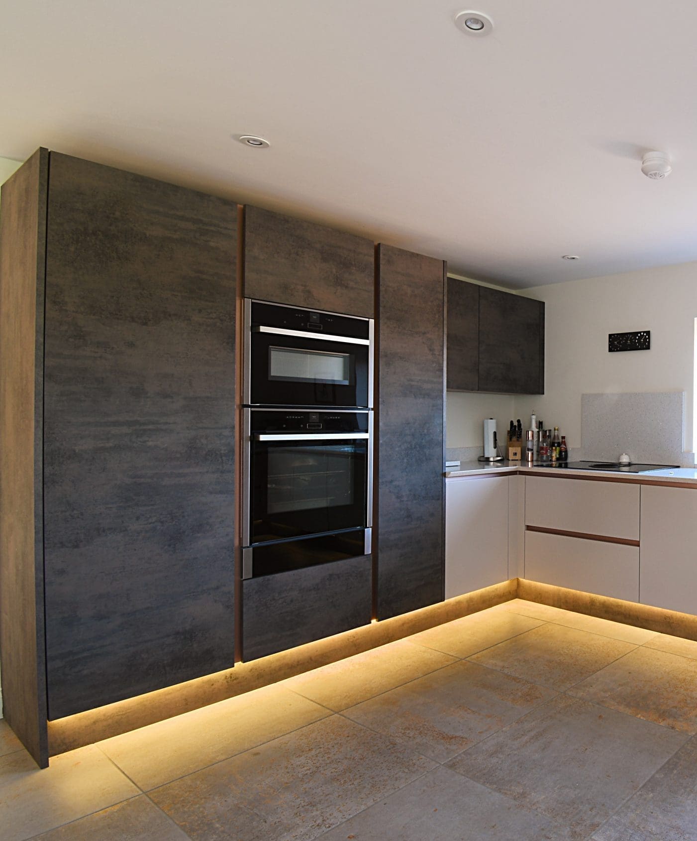 Oxide and Cashmere Kitchen with Flowers Two Tone with Neff Ovens Stonemill Kitchens Handleless Kitchen with Rose Gold Rails