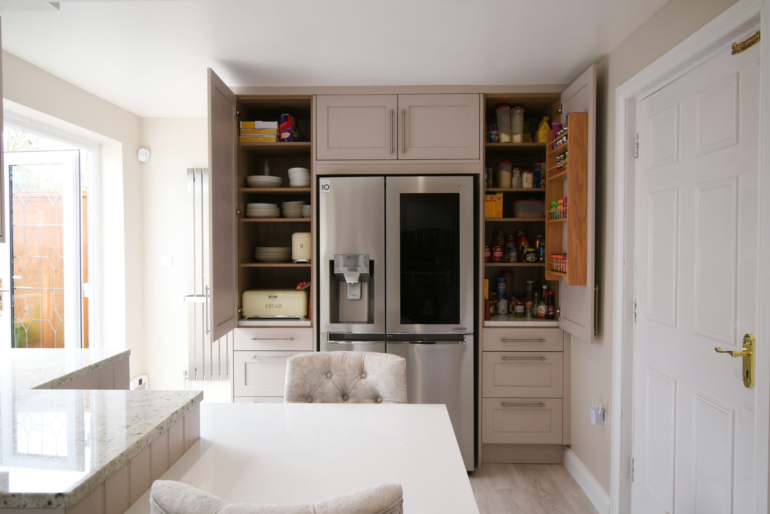 Stonemill Kitchens Cashmere Skinny Shaker Kitchen Granite Worktop Two Single Pantrys with Oak Spice Rack and Drawers. with american style fridge freezer