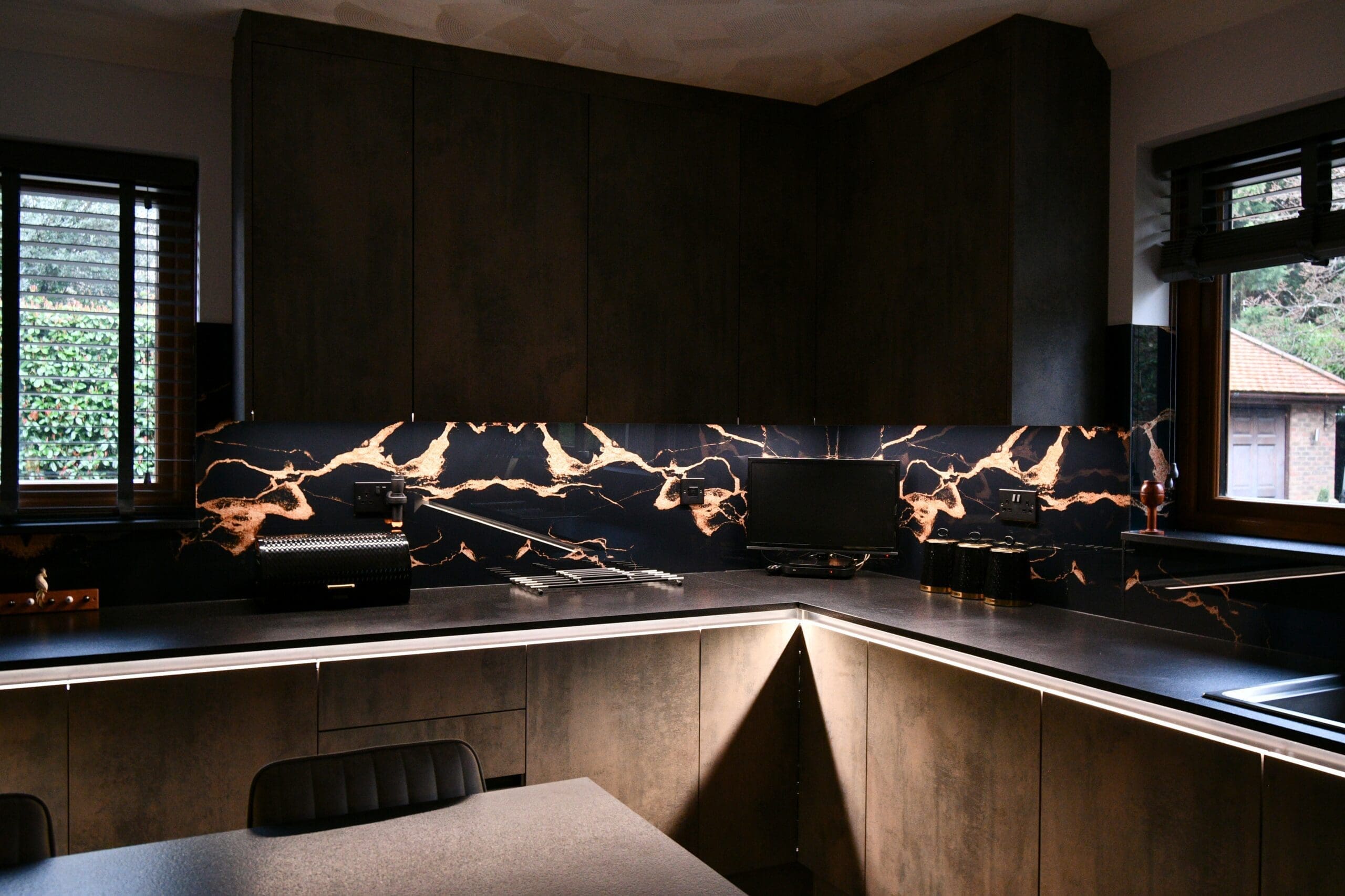 splashback in copper and black handleless kitchen